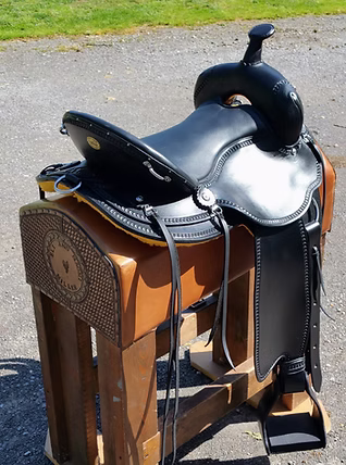 Brown trail saddle with standard border tooling and E-Z ride stirrups